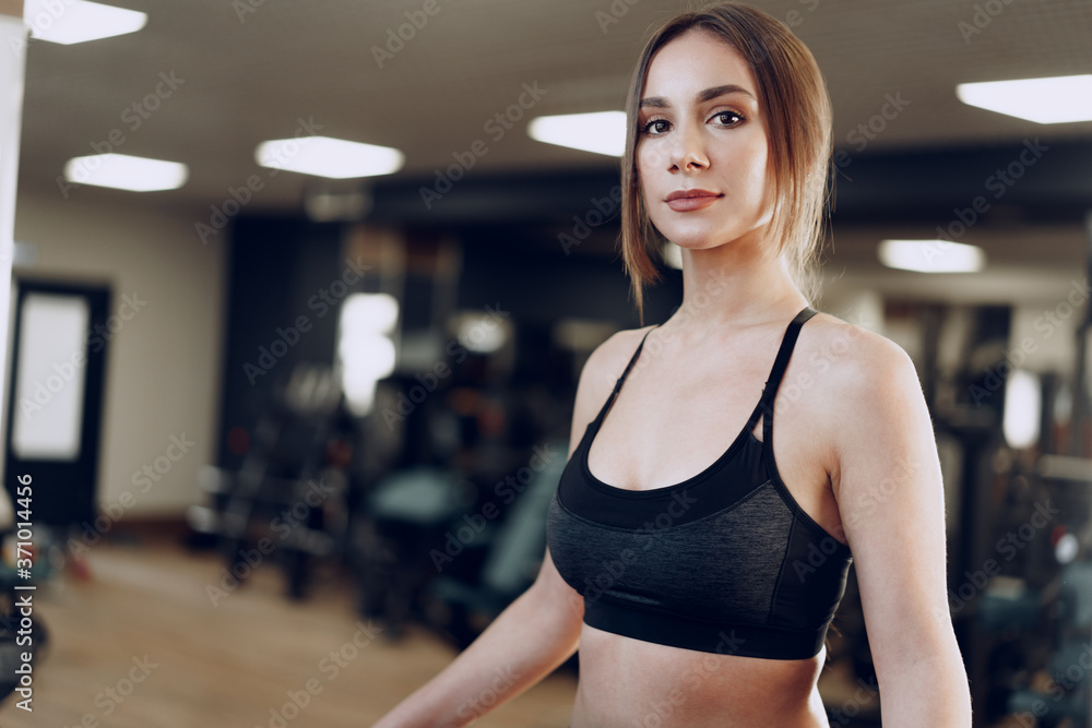 Portrait of a young sporty caucasian woman training in a fitness club Portrait of a young sporty caucasian woman training in a fitness club