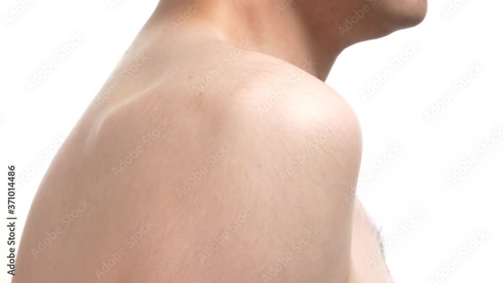 Closeup on the shoulder area of a young man. Human body part over a white screen background. Closeup on the shoulder area of a young man. Human body part over a white screen background.