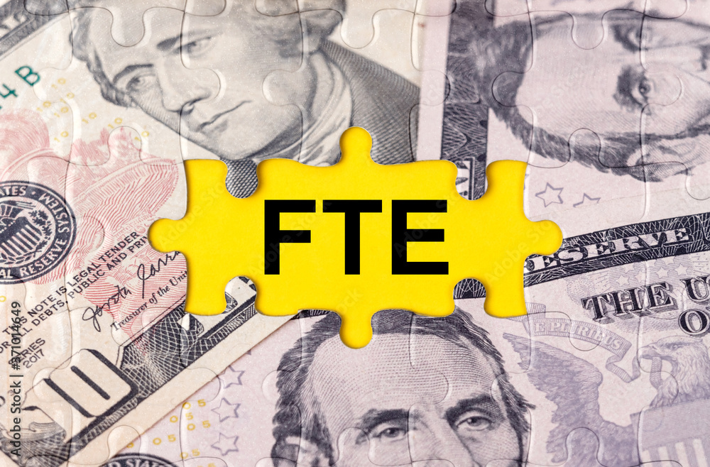 Fototapeta premium Puzzle with the image of dollars in the center of the inscription -FTE