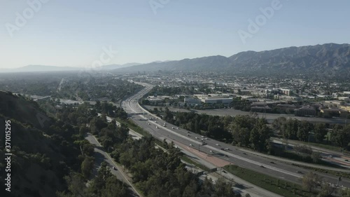 Los Angeles Golden State Freeway, Aerial View of Traffic Above River and Under Griffith Park on Sunny Californian Evening During Covid-19 Virus Outbreak photo