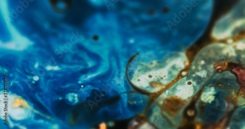 Macro Paint with Neon Color Palette. Oil Mixed with Blue and Green Dye and Paint.