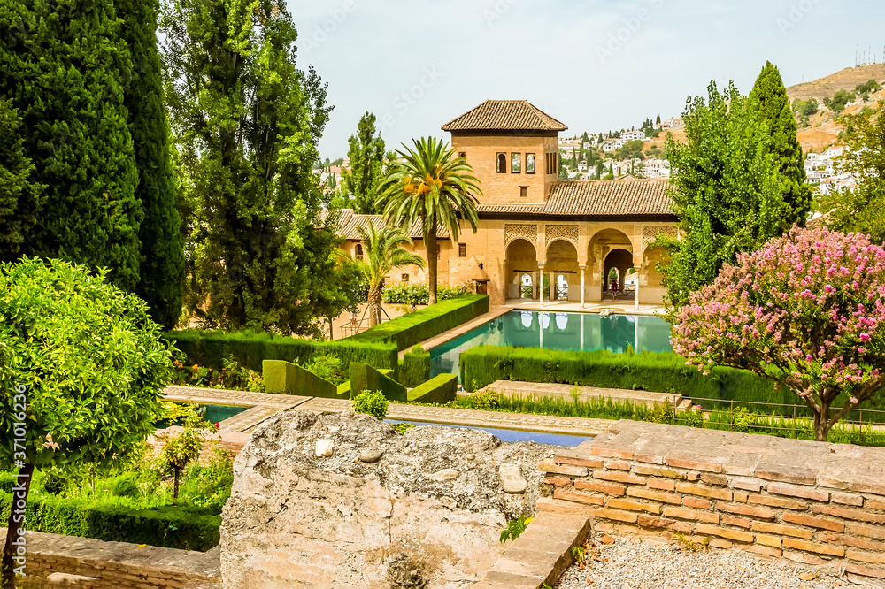 A view across formal gardens in the Alhambra district, Granada, in the summertime
