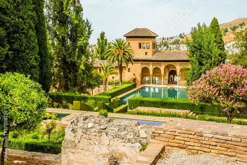 A view across formal gardens in the Alhambra district, Granada, in the summertime