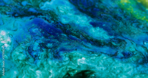 Closeup Paint with Vibrant Color Palette. Oil Mixed with Bright Teal and Blue Dye and Paint.