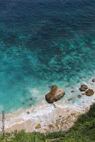 Top View of Suwehan beach on Nusa Penida Island, Bali, Indonesia. Amazing  view, green plants, white sand beach with rocky mountains and azure lagoon with clear water of Indian Ocean 
