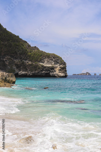 Suwehan beach on Nusa Penida Island, Bali, Indonesia. Amazing view, white sand beach with rocky mountains and azure lagoon with clear water of Indian Ocean 