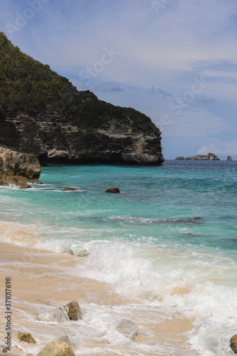 Suwehan beach on Nusa Penida Island, Bali, Indonesia. Amazing view, white sand beach with rocky mountains and azure lagoon with clear water of Indian Ocean 