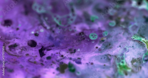 Macro Paint with Vibrant Color Palette. Oil Mixed with Bright Purple and Deep Green Dye and Paint.