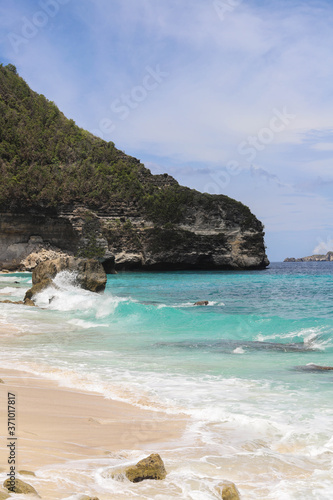 Suwehan beach on Nusa Penida Island, Bali, Indonesia. Amazing view, white sand beach with rocky mountains and azure lagoon with clear water of Indian Ocean 