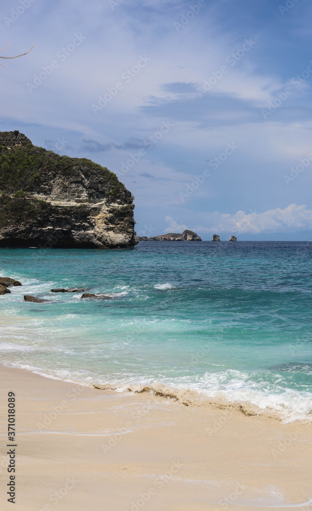 Suwehan beach on Nusa Penida Island, Bali, Indonesia. Amazing  view, white sand beach with rocky mountains and azure lagoon with clear water of Indian Ocean 