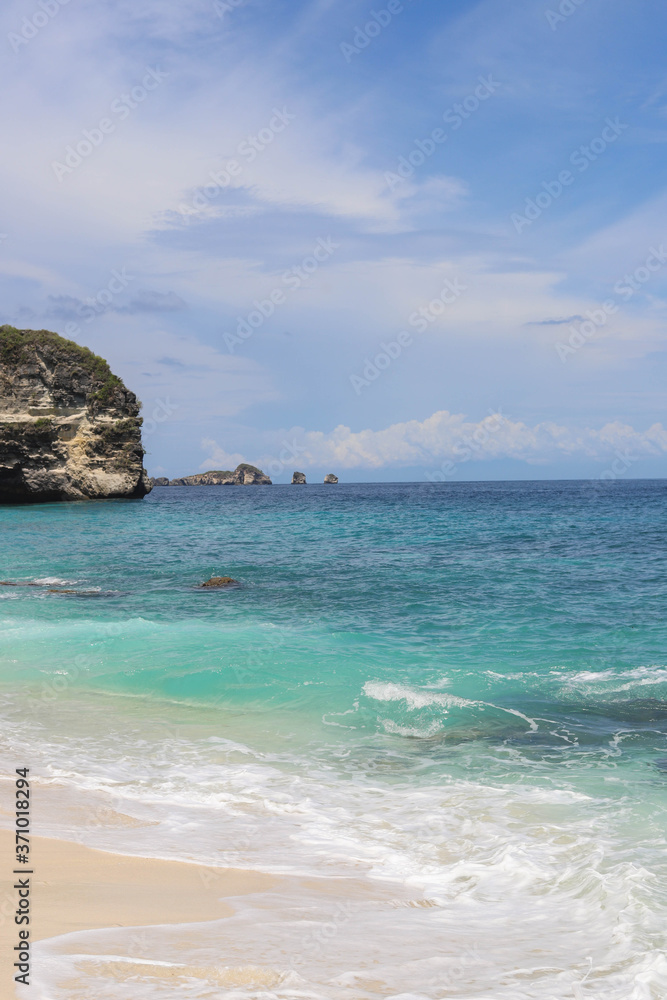 Suwehan beach on Nusa Penida Island, Bali, Indonesia. Amazing  view, white sand beach with rocky mountains and azure lagoon with clear water of Indian Ocean 