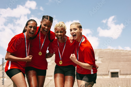 Female football team celebrating the victory photo