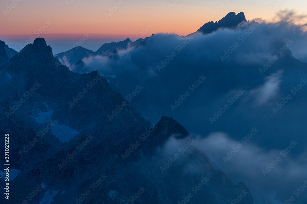 Panorama with fog and mountains in Banff, Alberta. Morning landscape with misty atmosphere.Beautiful nature background. First autumn day