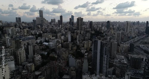2020 Beirut port explosion: aerial panoramic downtown scenic city view of tall skyscrapers and skyline on cloudy day, Lebanon, overhead drone pull back photo