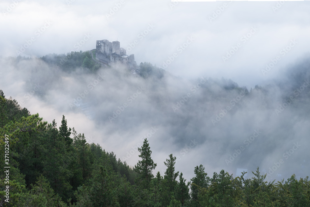 Slovakia - Ruin of castle Strecno. Beautiful autumn scenery of foggy valley in morning before sunrise. Europe. Beauty of nature concept background. 