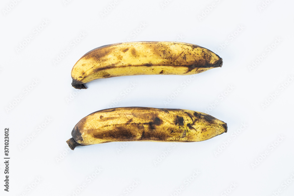 Two ripe bananas on isolated white background.