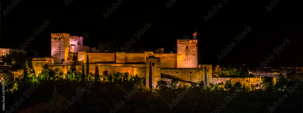 A view from Saint Nicholas Square, Granada, Spain towards the Alhambra district at night in the summertime