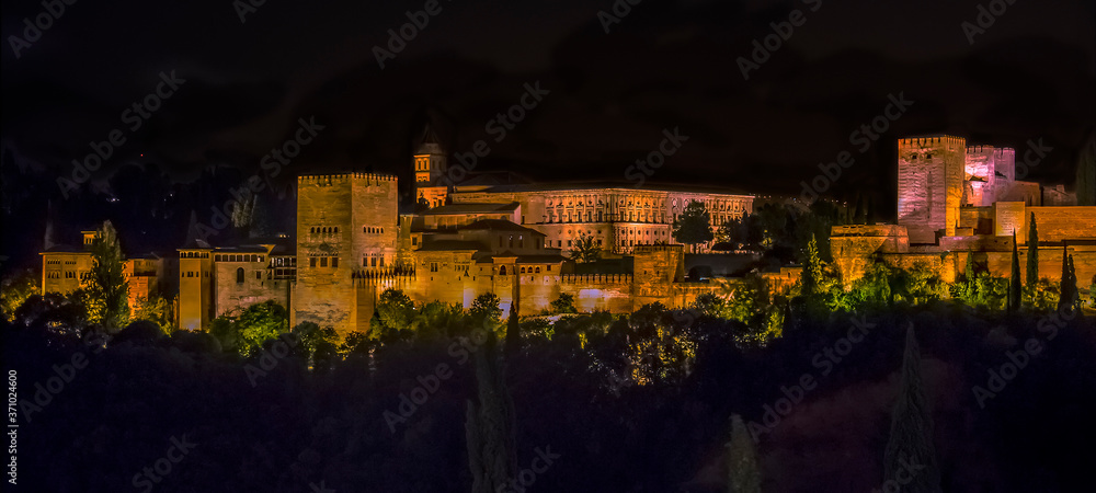 A view from Saint Nicholas Square, Granada, Spain towards the central part of the Alhambra district at night in the summertime