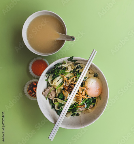 Photography Authentic Singapore hawker food: handmade ban mee, with condiments and broth served in a local food court