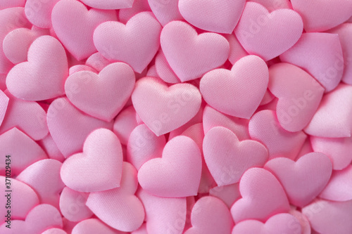 Pink satin hearts background. Love pink background. Top view