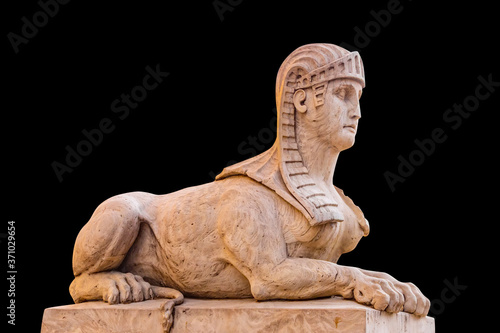 Old sphinx statue on black background