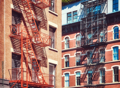 Old residential buildings with fire escapes, New York City, USA.