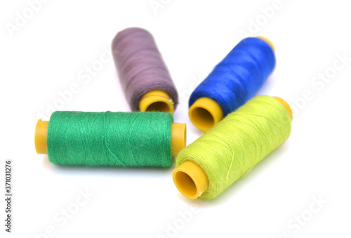 Spool of coloured thread isolated on white background. 