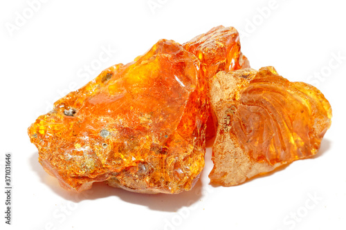 Transparent natural piece of amber on a white background. Copal. Fossil ancient resin from tropical trees. Sun stone. Mineral. Material for jewelry. Colored crystal. Inclusions in amber