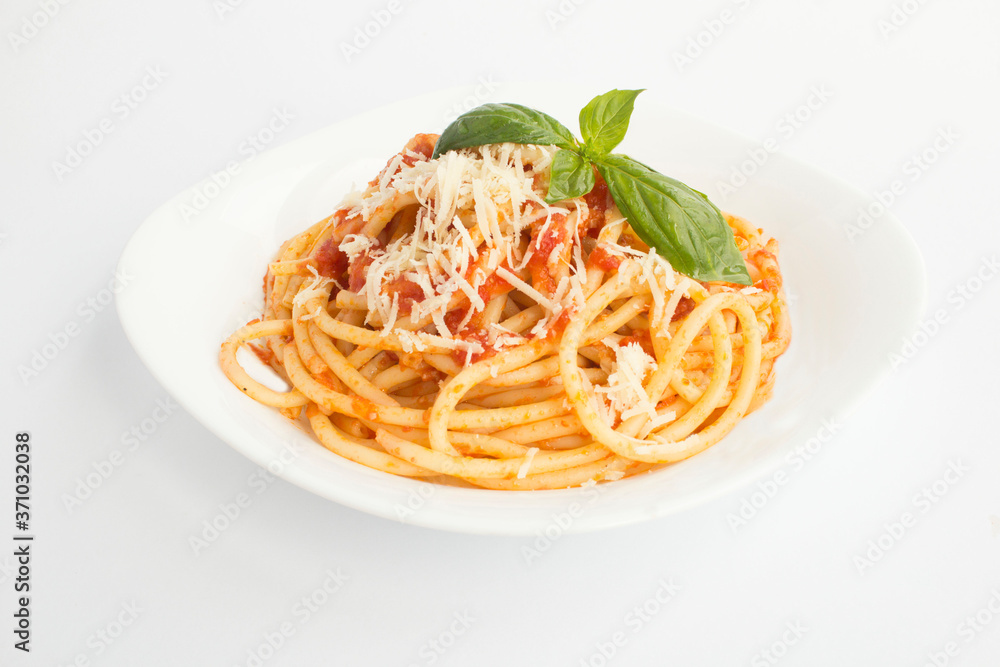 Closeup on italian pasta with tomato sauce and parmesan in the plate on the white surface