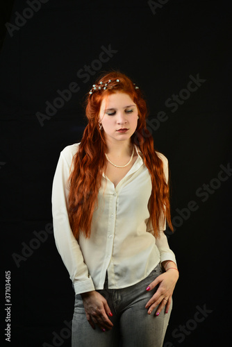 portrait of a beautiful young woman with elegant long red shiny hair , hairstyle. Studio