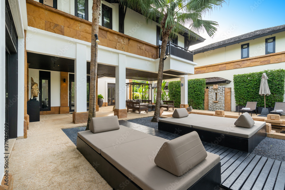 Exterior design of house, home and villa feature sun bed, palm tree, umbrella and outdoor shower on pool terrace