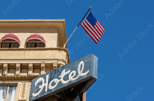Old Hotel sign and American Flag
