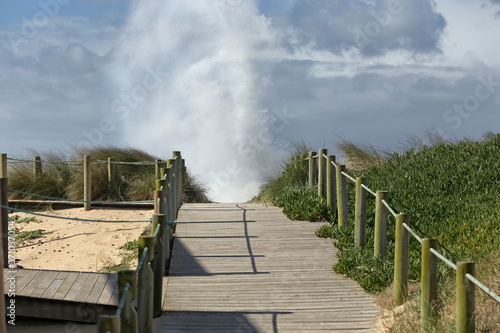Sand dune walkway by the sea seeing wave splash © Zacarias da Mata