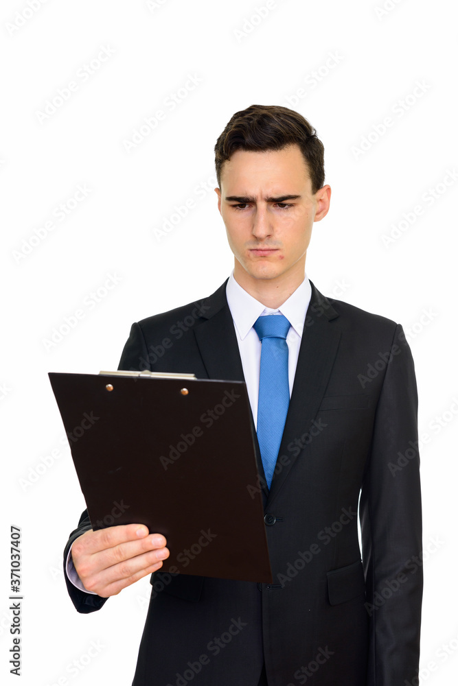 Studio shot of young handsome Caucasian businessman holding clipboard isolated against white background Studio shot of young handsome Caucasian businessman holding clipboard isolated against white background