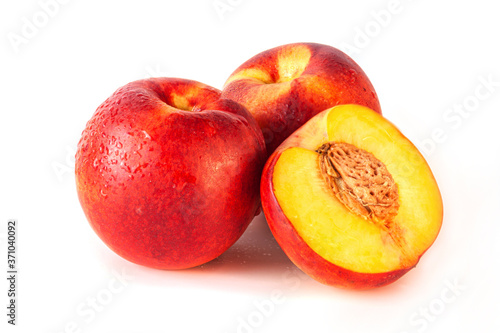 Peach or nectarine and peach slice with leaf on white background