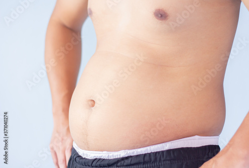 The authentic of a half-body man is (fat, belly) and uses natural light for image as a text illustration. © Scream