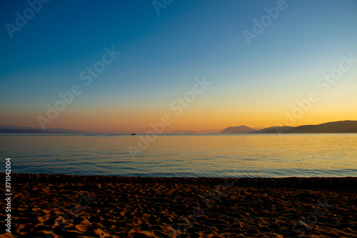 Beautiful sunset over the sea on Agia Eleni Beach, Skiathos, Greece © B. Van