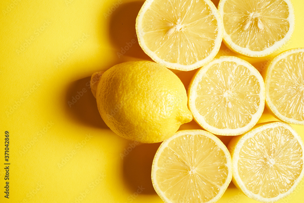 fresh lemons on a yellow minimalistic background