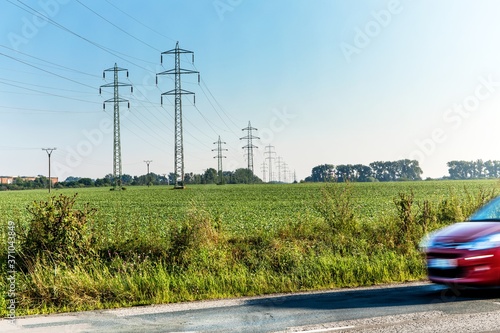 Power lines by the road. Energy concept. Electric car. High voltage transmission.
