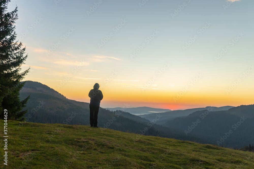 silhouette of a man standing on a mountain top silhouette of a man standing on a mountain top