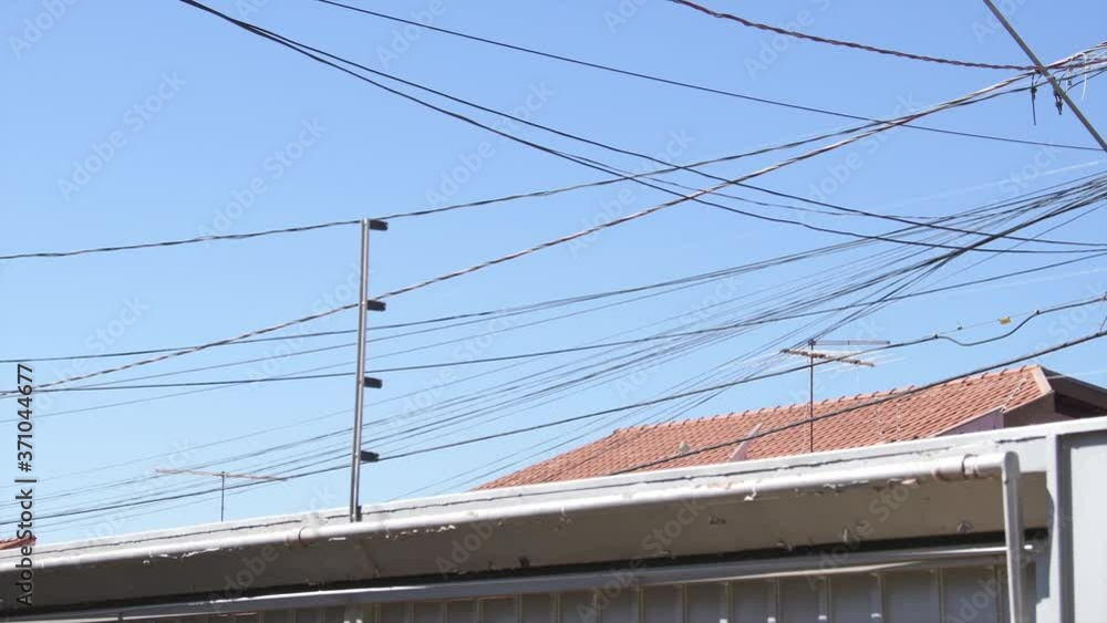 Electrical pole wiring of a residential area. Mess of light pole wires. Brazilian light pole with energy wires, phone and internet cables. Electrical pole wiring of a residential area. Mess of light pole wires. Brazilian light pole with energy wires, phone and internet cables.