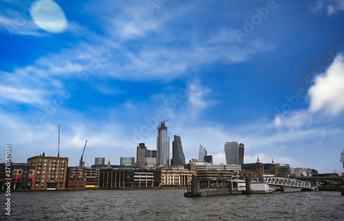 A view across the River Thames to the skyline of London, UK.