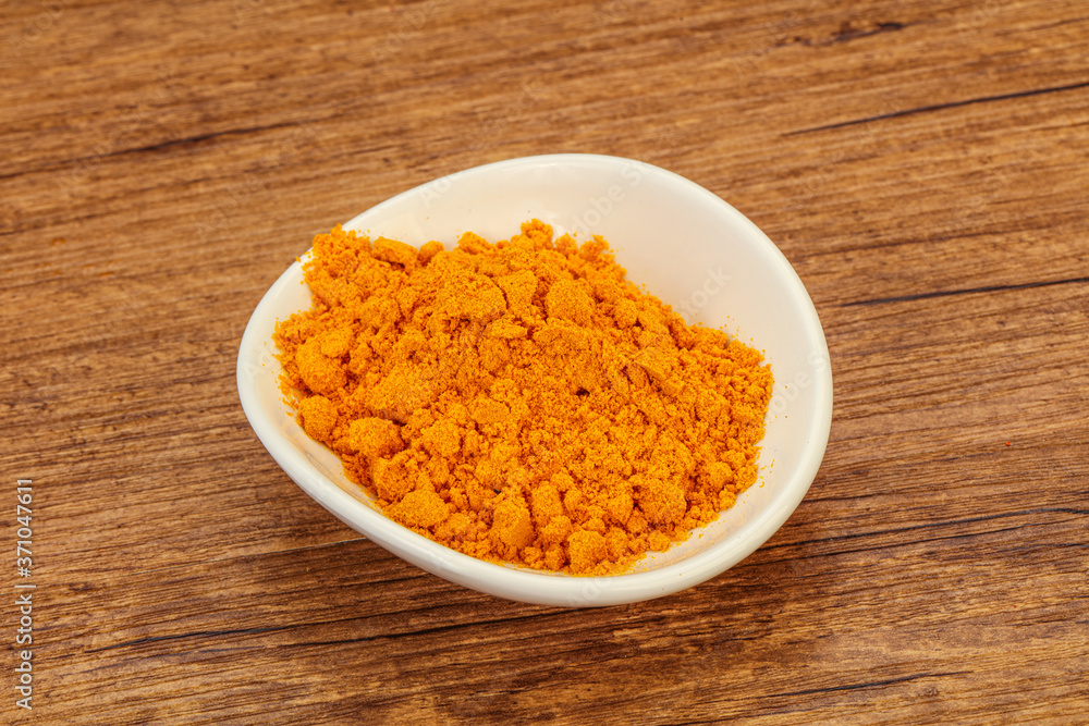 Tumeric powder in the bowl Tumeric powder in the bowl