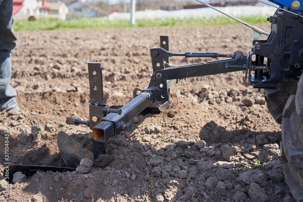 two plows plow the ground,man plows the field with a plow on the ground two plows plow the ground,man plows the field with a plow on the ground
