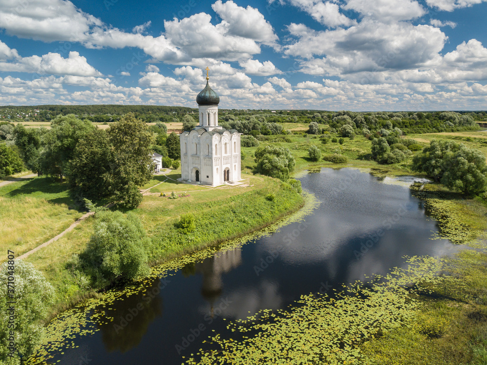 Big Panoramic aerial view of ancient Church of the Intercession of the Holy Virgin on the Nerl River at sunny summer day. Russia.