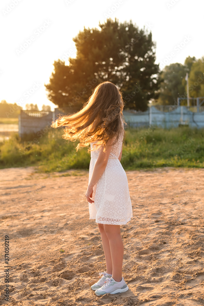 Young girl in wheat field at sunset Young girl in wheat field at sunset
