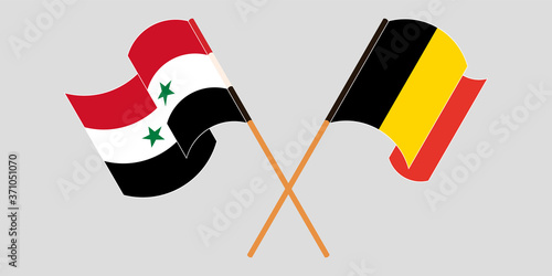 Crossed and waving flags of Syria and Belgium