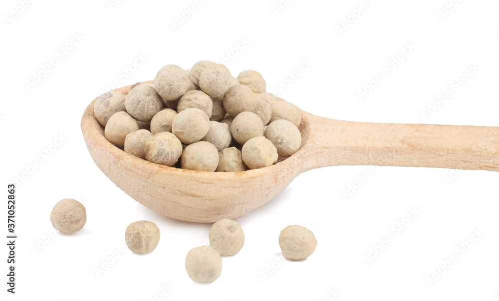 White pepper peas in the wooden spoon isolated on white White pepper peas in the wooden spoon isolated on white