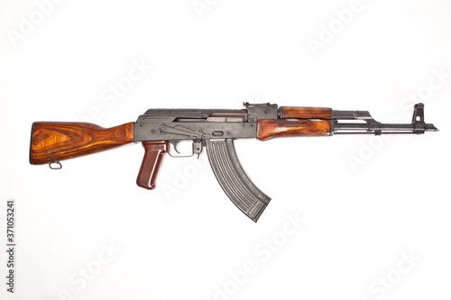 AK-47 with a magazine inserted on white background. photo
