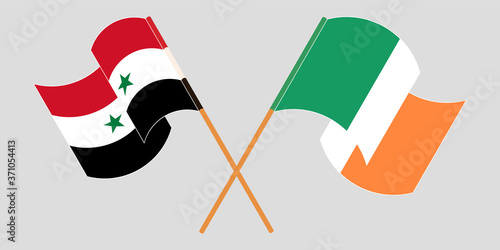 Crossed and waving flags of Syria and Ireland
